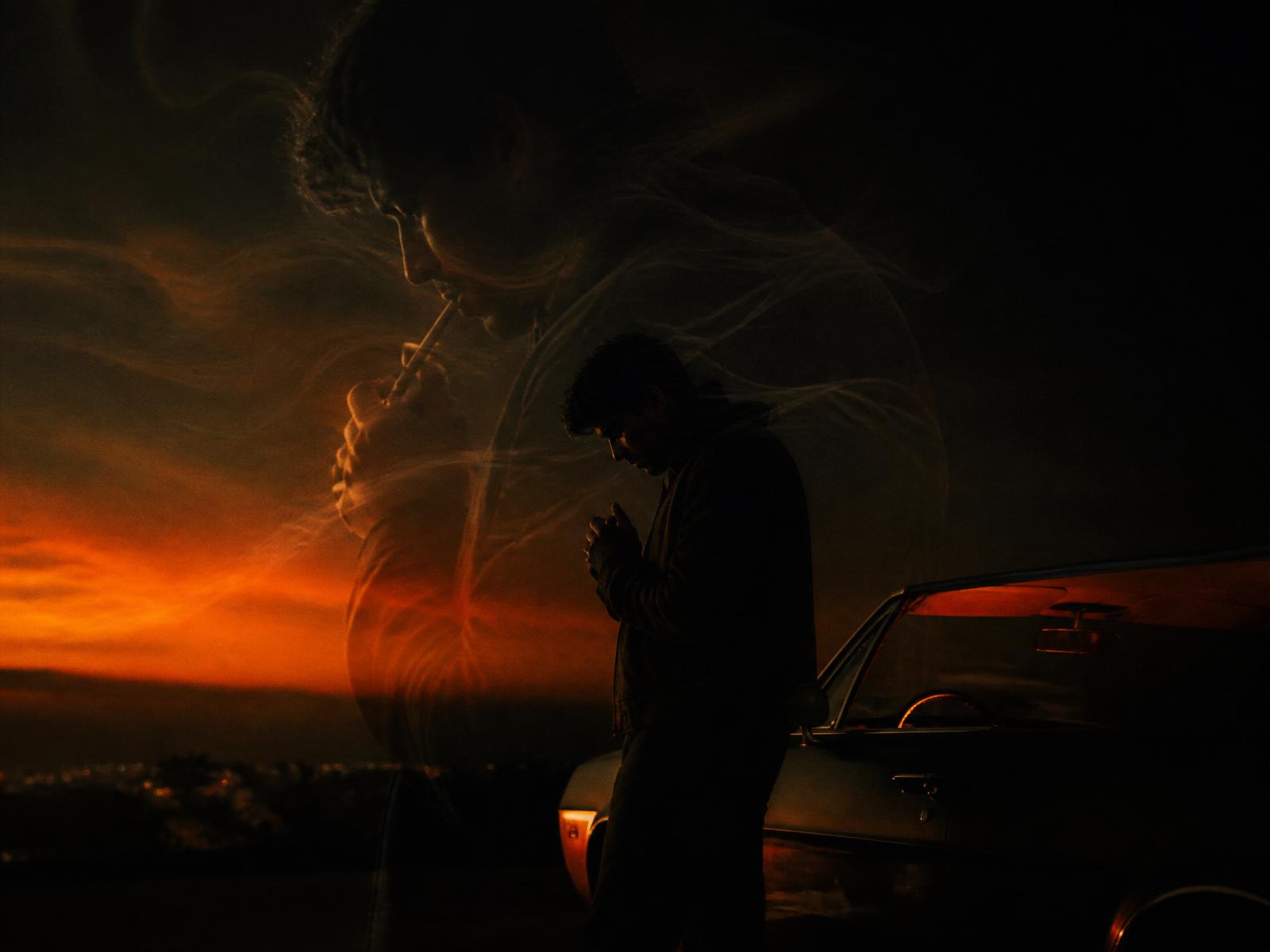 GhostFrame overlay showing a translucent reference photo lining up with a real subject near a car at golden hour